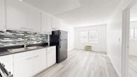 Located at 151 N Normandie Ave in Los Angeles' Koreatown neighborhood, this 1-bedroom, 1-bathroom unit offers a thoughtfully designed layout across a single floor. Light wood-style flooring flows throughout, creating a clean and cohesive look.

The open kitchen and living area form the heart of the unit. The kitchen features white cabinetry, a dark countertop, a stainless steel sink, a gas range, and a full-size refrigerator, all accented by a mosaic tile backsplash in muted greens and grays. A window with blinds allows natural light to fill the adjacent living area, which also includes a wall-mounted climate control unit.

The bedroom is a well-proportioned, bright room with a window providing natural light, a textured ceiling, and a full-width mirrored sliding closet that adds depth and reflective light to the space.

The bathroom is clean and functional, finished in white with a combination tub and shower, a white vanity with storage, and tile flooring in a neutral woven pattern.

The unit also includes a dedicated closet space near the entry. The overall design is bright, minimal, and move-in ready, making it a practical and comfortable home in a central Los Angeles location.