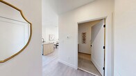 This well-appointed 1-bedroom, 1-bathroom unit is designed with a clean, modern aesthetic throughout its single floor. The open-concept kitchen and living area serves as the heart of the home, where light wood cabinetry, quartz countertops, and stainless steel appliances define the kitchen. A peninsula with bar seating provides both additional prep space and a casual dining option. Light hardwood-style flooring flows seamlessly throughout the main living areas, enhancing the sense of continuity and brightness. The living room is bathed in natural light from a large bank of windows offering urban views, creating an inviting and airy atmosphere. Elevated ceilings in portions of the living area add a sense of openness beyond the unit's compact footprint. The bedroom features a window with city views, light-toned walls, and warm hardwood flooring, offering a calm and comfortable retreat. A dedicated closet provides practical storage. The bathroom is finished with large-format tile flooring, a wood-toned vanity with a white countertop, and clean white walls, contributing to the unit's cohesive contemporary style. Every room reflects thoughtful design choices that maximize both functionality and visual appeal.