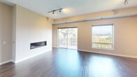 This contemporary apartment in Apex offers 1280 square feet of thoughtfully designed living space. The heart of the home is an open-concept living area, showcasing a sleek gas fireplace and large windows that flood the space with natural light. Sliding glass doors lead to a balcony, providing scenic outdoor views.

The gourmet kitchen is a chef's dream, featuring rich wood cabinetry, granite countertops, and stainless steel appliances. A central island with a breakfast bar adds functionality and style. The kitchen's blue subway tile backsplash adds a pop of color to the warm wood tones.

The apartment boasts three bedrooms, including a primary suite measuring 160 square feet. All bedrooms feature plush carpeting for comfort. The three bathrooms are modern and well-appointed, with one showcasing a double vanity with granite countertops and ample storage.

Throughout the apartment, you'll find a harmonious blend of materials, including gleaming hardwood floors in the main living areas and neutral-toned walls. Track lighting and designer light fixtures add ambiance and functionality. Two closets provide additional storage space.

This single-story apartment combines style, comfort, and convenience in a well-planned 1280 square foot layout, perfect for modern living in Apex.