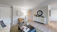 Located in Saint Petersburg, FL, this well-appointed 2-bedroom, 2-bathroom residence offers a thoughtfully designed single-floor layout with modern finishes throughout. The open living room features crown molding, a textured ceiling, and light wood-style flooring that flows seamlessly into the dining area. Sliding glass doors fill the space with natural light and provide direct access to a private balcony. The galley-style kitchen is equipped with white cabinetry, stainless steel appliances including an electric range and built-in microwave, a tile backsplash, and light countertops. A dedicated laundry area with a full-size washer and dryer adds everyday convenience. Both bedrooms are generously sized with natural light from large windows and ample closet space. The primary bedroom features a spacious layout with room for a full furniture suite. Both bathrooms are finished with white vanities, large-format marble-style tile surrounds, and tub-shower combinations. Light wood-style flooring, neutral gray tones, and clean white trim create a cohesive, contemporary ambiance throughout this move-in-ready Saint Petersburg residence.