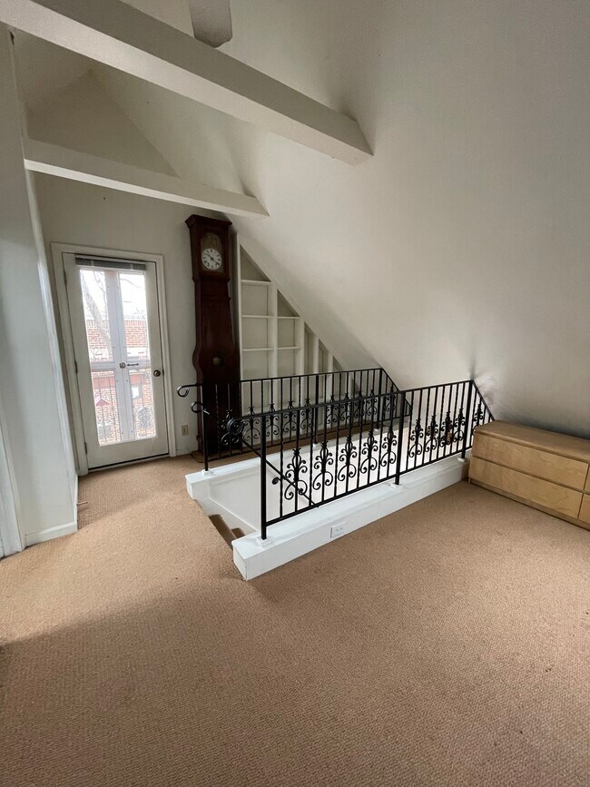 Upper floor with balcony and bookshelves. - 1200 W 32nd St