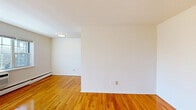 Located at 7 South Lake Drive in Hackensack, NJ, this one-bedroom, one-bathroom residence offers a well-organized single-floor layout designed for efficient, comfortable living. Warm-toned hardwood floors run throughout the space, lending a cohesive and inviting character to every room.

The open-plan kitchen and living area forms the heart of the home. The kitchen is equipped with stainless steel appliances, including a gas range, over-the-range microwave, and refrigerator, complemented by warm wood cabinetry, white countertops, and a stainless steel sink. The adjoining living area benefits from natural light streaming through large windows, creating a bright and airy atmosphere.

The bedroom is a well-proportioned, private retreat featuring two windows that invite generous natural light and outdoor views of the surrounding neighborhood. Baseboard heating and a wall-unit air conditioner ensure year-round comfort. The space also benefits from an impressive four closets distributed throughout the unit, providing ample storage.

The bathroom is finished with classic white subway tile surrounding the tub-shower combination, a white vanity, and a window that allows natural light into the space. Clean, neutral finishes throughout give the residence a fresh, move-in-ready feel.