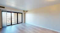 Located in the Duquesne Heights neighborhood of Pittsburgh, this single-floor unit at 5 Grand View Ave offers a clean, functional layout with a thoughtful mix of finishes throughout. The living area is a standout space, featuring light-toned hardwood flooring that reflects natural light and lends a fresh, airy feel to the room. A full-width sliding glass door opens to a private balcony, framed by brick exterior detailing, allowing ample daylight to fill the space and providing a pleasant outdoor connection.

The bedroom is generously sized, finished with plush neutral carpeting and a built-in closet with shelving and hanging rods, offering practical storage. A window provides additional natural light, completing the comfortable feel of the room.

The kitchen is efficiently designed with white cabinetry accented by warm wood trim, ample upper and lower storage, a stainless steel sink, a dishwasher, and a range. The white countertops provide a clean workspace throughout.

The bathroom features a full tub-shower combination with classic white square tile surround and chrome fixtures, maintaining a simple and well-maintained aesthetic.

Overall, the unit presents a neutral, move-in-ready environment with consistent finishes, practical storage solutions, and a bright, welcoming atmosphere throughout.