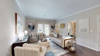 Located at 440 Cane Hill Rd in Antioch, Tennessee, this well-appointed two-bedroom, two-bathroom residence offers a thoughtfully designed single-floor layout. The open-concept living and dining area is anchored by rich hardwood-style flooring and elegant crown molding, creating a refined yet welcoming atmosphere. French doors allow natural light to pour into the living room, which flows seamlessly into the dining space. The kitchen features white shaker cabinetry, stainless steel appliances, subway tile backsplash, and granite-style countertops — a functional and stylish centerpiece of the home. The spacious primary bedroom is carpeted for comfort, includes a ceiling fan, large windows with outdoor views, and direct access to a dedicated walk-in closet with wire shelving. The second bedroom mirrors the same comfortable, light-filled character. Both bathrooms offer tiled flooring, a tub-shower combination, and white vanity cabinetry with warm lighting. Two closets throughout the home provide ample storage. The overall ambiance is clean, modern, and neutral — offering a versatile canvas suited to a variety of lifestyles.