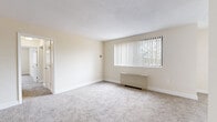 Located at 8484 16th St in Silver Spring, Maryland, this single-floor residence offers three bedrooms, two bathrooms, and a thoughtfully organized layout. The home features neutral-toned, wall-to-wall carpeting throughout the bedrooms and living areas, contributing to a warm and cohesive aesthetic.

The spacious living room is anchored by a large window with vertical blinds, allowing natural light to fill the room while offering views of the surrounding greenery. Each bedroom is generously sized, equipped with ceiling fans for added comfort, and served by ample closet space — with five closets distributed throughout the home. The primary bedroom provides a particularly comfortable retreat with its own dedicated closet and natural light.

The two bathrooms offer distinct finishes: one features a clean, all-white tub-shower combination, while the other showcases a floor-to-ceiling marble-style tile walk-in shower with sleek chrome fixtures, adding a refined touch to the space.

The kitchen is well-equipped with warm wood cabinetry, light granite-style countertops, a gas range, a dishwasher, and light wood-look flooring — creating a practical yet attractive cooking space. Two hallways connect the rooms efficiently, and the overall layout makes excellent use of the available floor space. This residence combines comfort and functionality in a convenient Silver Spring location.