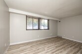 Located at 3630 Twana Dr in Des Moines, Iowa, this 2-bedroom, 1-bathroom home offers a clean and updated interior designed for comfortable everyday living. Light wood-style flooring runs throughout the entire space, complementing the neutral wall tones and white trim that create a bright, cohesive aesthetic.

The combined kitchen and living area forms the heart of the home. The kitchen is well-appointed with crisp white shaker cabinets, light marbled countertops, a stainless steel sink with a modern pull-down faucet, and black appliances including a range, dishwasher, and refrigerator. A pass-through opening connects the kitchen to the living area, enhancing the open feel of the space.

Both bedrooms are comfortably sized with neutral walls, textured ceilings, and windows fitted with blinds that allow for natural light and privacy. The primary bedroom includes a sliding-door closet with a built-in rod, offering practical storage. The second bedroom is equally well-lit with an exterior-facing window.

The bathroom features a clean, all-white tub and shower surround with chrome fixtures. A hallway connects the bedrooms and bathroom, with additional closet storage accessible along the way. The overall layout is efficient and functional, making excellent use of the available space throughout.