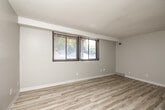 Located at 3630 Twana Dr in Des Moines, Iowa, this 2-bedroom, 1-bathroom home offers a clean and updated interior designed for comfortable everyday living. Light wood-style flooring runs throughout the entire space, complementing the neutral wall tones and white trim that create a bright, cohesive aesthetic.

The combined kitchen and living area forms the heart of the home. The kitchen is well-appointed with crisp white shaker cabinets, light marbled countertops, a stainless steel sink with a modern pull-down faucet, and black appliances including a range, dishwasher, and refrigerator. A pass-through opening connects the kitchen to the living area, enhancing the open feel of the space.

Both bedrooms are comfortably sized with neutral walls, textured ceilings, and windows fitted with blinds that allow for natural light and privacy. The primary bedroom includes a sliding-door closet with a built-in rod, offering practical storage. The second bedroom is equally well-lit with an exterior-facing window.

The bathroom features a clean, all-white tub and shower surround with chrome fixtures. A hallway connects the bedrooms and bathroom, with additional closet storage accessible along the way. The overall layout is efficient and functional, making excellent use of the available space throughout.