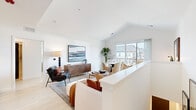 Located at 3223 W 111th St in Naperville, IL, this well-appointed 2-bedroom, 2-bathroom single-floor residence offers a thoughtfully designed open-concept layout. The living and dining area is anchored by soaring vaulted ceilings and bright white walls, creating an airy, welcoming ambiance. Large sliding glass doors flood the space with natural light and provide views of the surrounding neighborhood. The dining area comfortably accommodates a full table and chairs, while the living room offers generous space for relaxation.

The kitchen features white shaker cabinetry with matte black hardware, quartz countertops, a clean tile backsplash, and a full suite of stainless steel appliances including a gas range, built-in microwave, and French door refrigerator. The primary bedroom is a spacious retreat with a well-organized walk-in closet featuring custom shelving and hanging storage. The second bedroom is bright and inviting, benefiting from a large window with outdoor views.

Both bathrooms are finished with clean, modern details, including subway tile surrounds, white vanities with stone countertops, and matte black fixtures. A dedicated in-unit laundry closet with a full-size washer and dryer adds everyday convenience. Light wood-tone flooring flows throughout, tying the entire residence together with warmth and cohesion.