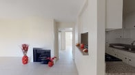 Located at 13990 Astoria St in the Sylmar neighborhood of Los Angeles, this single-story home offers a clean, bright interior defined by light-toned tile flooring that runs consistently throughout every room. The living area serves as a welcoming central space, highlighted by a classic fireplace that adds character and warmth. Adjacent to the living area is a pass-through counter with granite-style laminate surfaces, connecting seamlessly to the kitchen. The kitchen is well-equipped with white cabinetry, a stainless steel sink, granite-style countertops, and a stainless steel dishwasher, providing both function and style. The bedrooms are generously proportioned, each featuring large windows fitted with vertical blinds that allow natural light to filter through while maintaining privacy. One bedroom includes a built-in closet with sliding doors, offering practical storage. The home includes two bathrooms, each featuring a tub-and-shower combination enclosed by frosted sliding glass doors, a toilet, and a vanity with a sink. The neutral white and beige color palette used throughout creates a bright, open ambiance that is easy to personalize. This well-maintained single-story home provides a comfortable and functional layout suited for a variety of living arrangements.