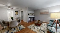 This 580 square foot apartment in Grand Prairie, TX, maximizes its compact layout with a thoughtful design. The space includes two bedrooms, one bathroom, and an open-concept living area. Throughout the apartment, warm wood flooring creates a cohesive look and adds a touch of elegance.

The primary bedroom, measuring 130 square feet, features large sliding glass doors that flood the space with natural light. A modern gold-framed bed and geometric-patterned bedding add a contemporary flair. Stylish artwork and a unique patterned dresser complete the room's aesthetic.

The living room seamlessly integrates with the dining area, showcasing a harmonious blend of form and function. A plush teal sofa anchors the living space, complemented by a sleek glass coffee table and modern lighting. The dining area features a chic table with gold accents and comfortable grey chairs, perfect for entertaining or casual meals.

The kitchen, while not fully visible in the images, appears to have a pass-through window or bar area connecting it to the living space, enhancing the open feel of the apartment. Thoughtful details like strategically placed artwork, plants, and decorative elements contribute to the overall modern and inviting atmosphere.

The bathroom, though compact, is efficiently designed with clean lines and a neutral color palette. A patterned shower curtain adds visual interest, while built-in storage helps maximize space.

Overall, this apartment offers a well-designed living space that makes the most of its 580 square feet, combining style and functionality in a single-floor layout.