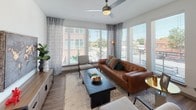 This single-story residence is thoughtfully designed with a contemporary aesthetic, combining clean lines, neutral tones, and modern finishes throughout. The open-concept floor plan connects the kitchen, dining, and living areas, creating a cohesive and functional living space finished with wood-look flooring.

The kitchen serves as a central hub, anchored by a substantial island with a white quartz countertop, undermount sink, and pendant lighting overhead. Light wood cabinetry extends to the ceiling, complemented by a subway tile backsplash and a full suite of stainless steel appliances, including a French door refrigerator, range, and microwave. A pantry closet provides additional storage.

The living area is defined by an impressive wall of large windows that flood the room with natural light and frame views of the surrounding neighborhood. A ceiling fan adds comfort to the bright, airy space.

Two bedrooms feature plush carpeting, ceiling fans, and windows with outdoor views. Each is served by its own bathroom. One bathroom offers a full tub-shower combination with marble-style tile surround and a long vanity with ample storage. The second features a walk-in shower with stone-look tile and a single-sink vanity.