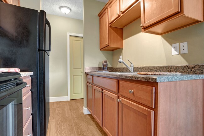 A kitchen with granite countertops and stainless steel appliances - The Mews