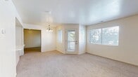 Located at 1580 W 3940 S in West Valley City, Utah, this single-floor, 2-bedroom, 2-bathroom home offers a practical and comfortable layout. The living and dining area is bright and welcoming, featuring plush carpet flooring, neutral walls, a classic chandelier overhead, and multiple windows that fill the space with natural light. A rear door provides convenient outdoor access directly from the main living area.

The kitchen is efficiently designed with light wood cabinetry, ample counter space, tile flooring, and included appliances — among them a refrigerator, electric range, dishwasher, and range hood.

The generously sized primary bedroom offers soft carpeting, a window for natural light, and access to a spacious walk-in closet outfitted with dual wire shelving and hanging rods along both walls. The second bedroom is similarly carpeted and bright. Both bathrooms feature tile flooring, vanities with light wood cabinetry, and tub/shower combinations equipped with grab bars. A dedicated laundry room houses a full-size washer and dryer alongside the home's utility systems. Throughout the home, the clean, neutral palette and functional design make for a move-in ready living space.