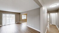 Located at 3838 West Sylvania Avenue in Toledo, Ohio, this one-bedroom, one-bathroom unit offers a well-organized and efficiently designed single-floor layout. The open living area is finished with warm wood-look laminate flooring, neutral taupe walls, and clean white baseboards, creating a bright and cohesive aesthetic. Baseboard heating runs throughout, and a sliding glass door leads to a private balcony, allowing natural light to fill the space.

The kitchen is thoughtfully appointed with white shaker-style cabinetry, granite countertops, a subway tile backsplash, and stainless steel appliances including a refrigerator, dishwasher, and range. Light ceramic tile flooring and a ceiling fan complete the functional yet stylish kitchen space, which opens conveniently into the living area.

The bedroom offers comfortable proportions, continuing the wood-look flooring, and includes a built-in closet with bi-fold doors and a window with natural light. The full bathroom features a white vanity with granite countertops, a mirrored medicine cabinet, a tiled shower/tub surround, and accessibility-friendly grab bars, alongside a natural light-providing window. Two hallways connect the spaces efficiently, contributing to the unit's practical and streamlined flow throughout.