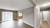 Located at 3838 West Sylvania Avenue in Toledo, Ohio, this one-bedroom, one-bathroom unit offers a well-organized and efficiently designed single-floor layout. The open living area is finished with warm wood-look laminate flooring, neutral taupe walls, and clean white baseboards, creating a bright and cohesive aesthetic. Baseboard heating runs throughout, and a sliding glass door leads to a private balcony, allowing natural light to fill the space.

The kitchen is thoughtfully appointed with white shaker-style cabinetry, granite countertops, a subway tile backsplash, and stainless steel appliances including a refrigerator, dishwasher, and range. Light ceramic tile flooring and a ceiling fan complete the functional yet stylish kitchen space, which opens conveniently into the living area.

The bedroom offers comfortable proportions, continuing the wood-look flooring, and includes a built-in closet with bi-fold doors and a window with natural light. The full bathroom features a white vanity with granite countertops, a mirrored medicine cabinet, a tiled shower/tub surround, and accessibility-friendly grab bars, alongside a natural light-providing window. Two hallways connect the spaces efficiently, contributing to the unit's practical and streamlined flow throughout.