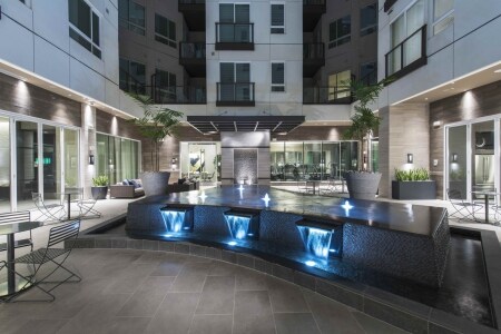 1000 Grand By Windsor Apartments Los Angeles Ca Atrium With Cafe Style Seating And Water Feature 1000 Grand By Windsor