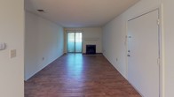 Located at 843 Issaqueena Trl in Clemson, South Carolina, this single-floor home offers a practical and comfortable layout with consistent wood-look flooring running throughout the entire space. The living room is a standout area, featuring a classic fireplace with a white surround and sliding glass doors fitted with vertical blinds that allow natural light to fill the room. Adjacent to the living area, a dining space is accented by a chandelier and includes a large double-door closet for added storage. The galley-style kitchen is well-equipped with warm wood cabinetry, granite-look countertops, and black appliances including a refrigerator, electric range, and over-the-range microwave. The bedrooms are bright and airy, each outfitted with ceiling fans and light-filtering windows that bring in views of the surrounding greenery. The bathrooms feature full tub-shower combinations with chrome fixtures and wood-toned vanities, maintaining a clean and functional aesthetic. Ceiling fans are present throughout multiple rooms, enhancing comfort year-round. The overall ambiance of the home is clean, neutral, and move-in ready, making it a versatile space suited for a variety of living arrangements in the Clemson area.