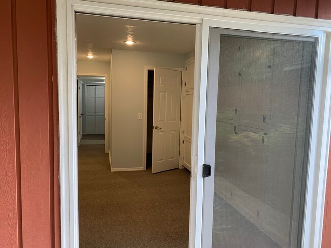 Enter into the living, dining area which contains 5x6 storage closet and a wall of storage cabinets - 4135 NW Carlton Ct
