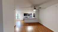 Located at 3000 Greenridge Dr in Houston, TX 77057, this single-floor residence offers a thoughtfully designed open-concept layout that seamlessly connects the living, dining, and kitchen areas. Rich hardwood flooring flows throughout the main living spaces, complemented by ceiling fans that add both style and function.

The kitchen is a standout feature, showcasing dark espresso cabinetry, light granite countertops, a tile backsplash, and a full suite of stainless steel appliances including a gas range, microwave, and refrigerator. A peninsula with a double sink provides additional prep space and separates the kitchen from the living area. Track lighting illuminates the space effectively. A stacked in-unit washer and dryer is conveniently located just off the kitchen.

The bedrooms are carpeted for comfort, each equipped with a ceiling fan and windows with blinds that allow natural light while maintaining privacy. One room features a built-in shelving unit, offering practical display and storage options.

The bathroom is finished in clean white tile, featuring a glass-enclosed shower and a separate soaking tub, creating a bright and functional space. Throughout the residence, neutral tones and consistent finishes contribute to a cohesive and inviting atmosphere.