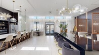 Located at 2333 NW 167th Street in Miami Gardens, Florida, this single-floor lounge offers a well-appointed and elegantly designed gathering space. The interior is defined by a cohesive modern aesthetic, combining white marble-look tile flooring, dark wood wall paneling, and gold metallic accents throughout. Sculptural brass-and-glass globe chandeliers serve as striking focal points, suspended from elevated ceilings that lend the space a sense of openness and grandeur. Clerestory windows along the upper walls allow natural light to filter in, complementing the bright, airy atmosphere created by sheer white drapery framing the glass entry doors.

The layout is thoughtfully zoned to accommodate a variety of uses. A bar-style counter lined with plush charcoal velvet chairs on gold circular bases anchors the central area, while a separate section features intimate semi-private booths framed by decorative carved wood panels and warm wall sconces. A communal dining area with bar-height seating provides additional flexibility for gatherings.

A kitchenette area includes a large white island with bar seating, open shelving with decorative accessories, and stainless steel appliances set against a dark accent wall. Glass doors at the entrance open to an outdoor view, reinforcing the lounge's connection to its surroundings and enhancing its overall welcoming ambiance.