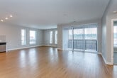 Located at 1600 Genessee St in Kansas City, Missouri, this modern single-floor unit offers a thoughtfully designed open-concept layout with a clean, contemporary aesthetic throughout. The expansive main living area features warm hardwood flooring, recessed lighting, and soft neutral-toned walls, creating a bright and welcoming atmosphere. Large windows allow abundant natural light to flow through the space while framing views of the surrounding cityscape.

The kitchen is seamlessly integrated into the living area and is outfitted with stainless steel appliances, including a refrigerator, range with hood vent, and dishwasher. Sleek white cabinetry, a tiled backsplash, and generous counter space complete the modern culinary space.

The bedrooms are carpeted for comfort and feature large windows with urban views, including sliding glass doors in one bedroom that open to an outdoor balcony. The primary bathroom is well-appointed with a dual-sink vanity, a walk-in closet with built-in shelving, and a glass-enclosed shower. A secondary bathroom includes a combined tub and shower with sliding glass doors. Hardwood flooring carries through the bathrooms, tying the overall design together cohesively.