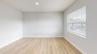 Located at 11312 N 52nd St in Tampa, Florida, this single-story 2-bedroom, 1-bathroom home offers a clean, modern aesthetic with a practical and well-organized layout. Throughout the home, light wood-style flooring and crisp white walls create a bright, cohesive atmosphere that maximizes the sense of space.

The combined kitchen and living area serves as the heart of the home. The kitchen features white cabinetry, a black electric range with overhead ventilation, recessed lighting, and ample counter space — all finished in a clean, contemporary style. The adjacent living area provides an open canvas with natural light streaming in through a window near the front entry door.

A central hallway connects the main living spaces to the bedrooms and bathroom, with recessed ceiling lighting and attic access overhead. The primary bedroom is a comfortable, well-proportioned room with a large sliding double-door closet, a ceiling vent, and clean white walls. The second bedroom features a window with outdoor views, providing natural light and ventilation.

The shared bathroom is outfitted with a full tub-shower combination, chrome fixtures, and a toilet — finished in a simple, clean white throughout.

The home's consistent flooring, neutral tones, and efficient use of space make it a functional and move-in-ready residence in the Temple Terrace area of Tampa.