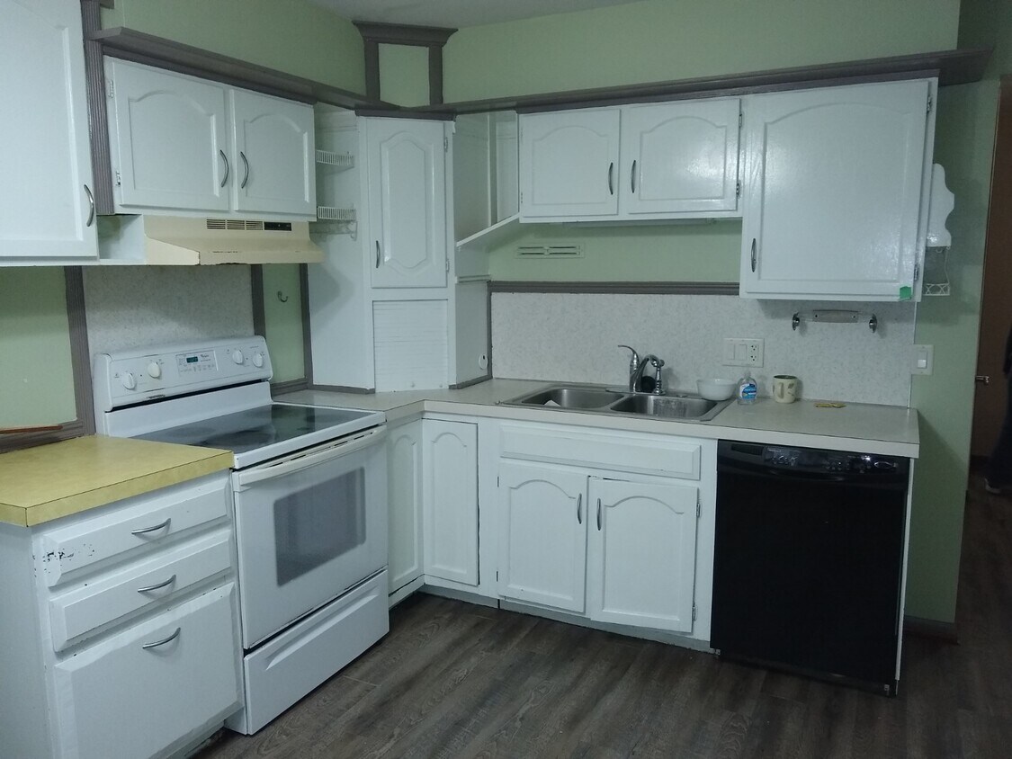 Kitchen has plenty of storage, and a dish washer too. Flat glass-top stove. - 664 E 12th St