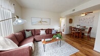 Located at 2410 S Mission Rd in Tucson, AZ, this single-floor, 2-bedroom, 2-bathroom home offers a well-organized and efficiently designed layout. The living room welcomes you with warm wood-look flooring, a textured ceiling, and a window that invites natural light and outdoor greenery views, creating a bright and inviting atmosphere. The adjacent dining area features the same wood-look flooring, a ceiling fan, and a cozy nook ideal for everyday meals. The galley-style kitchen is outfitted with rich wood cabinetry, granite-style countertops, a double sink, and black appliances including a range, microwave, and refrigerator, offering a functional and well-appointed cooking space. Both bathrooms are finished with warm wood vanities, granite-style countertops, and wood-look flooring, with one bathroom featuring a shower-tub combination. The two bedrooms are carpeted and receive natural light through windows with outdoor views. The primary bedroom offers a comfortable, serene retreat, while the second bedroom provides versatile space suitable as a guest room or home office. A dedicated closet rounds out the storage offerings. Throughout the home, a consistent palette of warm neutrals and natural wood tones creates a cohesive and welcoming ambiance.