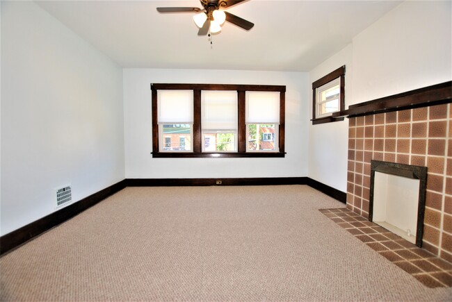 Living room with decorative fireplace. - 400 Orchard Ave