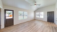 Located at 3507 W Mississippi Ave in Chickasha, Oklahoma, this single-story home offers four bedrooms and two full bathrooms within a well-designed, functional layout. The open-concept living area features vaulted ceilings and a ceiling fan, with large windows that flood the space with natural light and views of the outdoors. Light-toned luxury vinyl plank flooring runs consistently throughout the living areas and bedrooms, creating a clean, cohesive aesthetic.

The kitchen is a standout feature, boasting granite countertops, a large center island with a built-in sink, gray shaker-style cabinetry, and stainless steel appliances, including a refrigerator, range, and microwave. Recessed lighting adds a modern touch to the space.

Each bedroom is well-proportioned and outfitted with ceiling fans and natural light. The primary bedroom includes direct access to a bathroom. Both bathrooms echo the home's design language, featuring granite-top vanities with gray cabinetry and framed mirrors. One bathroom includes a tub-shower combination.

The attached two-car garage is spacious, finished with recessed lighting, an automatic opener, and an electrical panel, offering practical utility. Two closets provide additional storage throughout the home.