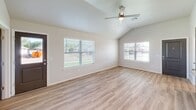 Located at 3507 W Mississippi Ave in Chickasha, Oklahoma, this single-story home offers four bedrooms and two full bathrooms within a well-designed, functional layout. The open-concept living area features vaulted ceilings and a ceiling fan, with large windows that flood the space with natural light and views of the outdoors. Light-toned luxury vinyl plank flooring runs consistently throughout the living areas and bedrooms, creating a clean, cohesive aesthetic.

The kitchen is a standout feature, boasting granite countertops, a large center island with a built-in sink, gray shaker-style cabinetry, and stainless steel appliances, including a refrigerator, range, and microwave. Recessed lighting adds a modern touch to the space.

Each bedroom is well-proportioned and outfitted with ceiling fans and natural light. The primary bedroom includes direct access to a bathroom. Both bathrooms echo the home's design language, featuring granite-top vanities with gray cabinetry and framed mirrors. One bathroom includes a tub-shower combination.

The attached two-car garage is spacious, finished with recessed lighting, an automatic opener, and an electrical panel, offering practical utility. Two closets provide additional storage throughout the home.