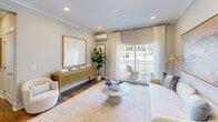 Located at 50 Newport Blvd in Port Wentworth, Georgia, this thoughtfully designed 2-bedroom, 2-bathroom residence offers a comfortable and stylish single-floor layout. Wood-look flooring flows throughout, tying together each room with a warm, cohesive aesthetic.

The open-concept kitchen is a standout feature, showcasing white shaker cabinetry, stainless steel appliances, a soft aqua tile backsplash, and a shiplap-paneled island with bar seating — ideal for casual dining and entertaining. Crown molding and recessed lighting add refined detail to the kitchen and adjoining living area.

The living room is bright and welcoming, with a sliding glass door that opens to a private balcony and fills the space with natural light. A wall-mounted mini-split system provides efficient climate control throughout.

The primary bedroom is generously sized, featuring multiple windows that invite natural light, a wall-mounted mini-split unit, and a mirrored sliding closet. Its en-suite bathroom offers a white vanity and a clean, neutral finish. The second bedroom includes a mirrored closet and easy access to the second full bathroom, which features a white vanity, wood-look flooring, and a shower-tub combination. This residence combines functional design with modern coastal-inspired touches throughout.