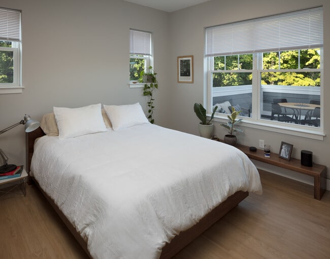 Bedroom with View to Private Deck (select units) - Founders Square — New Luxury Apartments in a Walkable Downtown