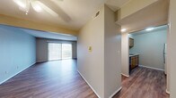 Located at 6625 N Big Hollow Rd in Peoria, Illinois, this single-floor residence offers a thoughtfully laid-out living space with a clean, neutral aesthetic throughout. The open living and dining area is anchored by rich hardwood-style flooring and features a full-width sliding glass door with vertical blinds, allowing generous natural light and direct access to an outdoor patio with scenic views. A ceiling fan enhances comfort in the adjoining entry area, which also features matching hardwood-style flooring.

The galley-style kitchen is efficiently designed with warm wood cabinetry, light granite-look countertops, and a full suite of appliances including a refrigerator, electric range, and dishwasher. Hardwood-style flooring continues throughout the kitchen, adding cohesion to the space.

The bedrooms are carpeted for comfort, with one featuring dual sliding-door closets and a ceiling fan, providing generous storage. A secondary bedroom also includes hardwood-style flooring and a ceiling fan. The full bathroom offers a long vanity with wood cabinetry, a white countertop, a soaking tub, and a separate walk-in closet. Textured ceilings and consistent neutral wall tones lend a calm, unified atmosphere throughout the entire residence.