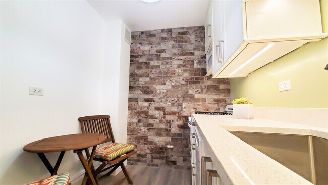 The kitchen comes fully loaded with dishwasher and microwave! - 400 Central Park W