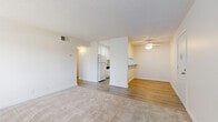 Located at 3535 Marconi Ave in Arden-Arcade, California, this 2-bedroom, 1-bathroom residence offers a thoughtfully laid-out single-level floor plan. The living room is bright and welcoming, featuring plush neutral carpeting, a large sliding glass door with vertical blinds that floods the space with natural light, and a ceiling fan for year-round comfort. Adjacent to the living room, the dining area features warm wood-look flooring, a ceiling fan, and a convenient pass-through counter connecting directly to the kitchen, making it ideal for everyday meals. The galley-style kitchen is efficiently designed with white cabinetry, light granite-style countertops, wood-look flooring, and white appliances including a refrigerator and electric range. Both bedrooms are carpeted and well-lit, each with windows dressed in vertical blinds and generous closet space — including a walk-in closet with dual shelving in the primary bedroom. The full bathroom is clean and functional, featuring a tub-shower combination, a granite-topped vanity, and wood-look tile flooring. Throughout the unit, textured ceilings, crisp white walls, and consistent neutral finishes create a cohesive, move-in-ready aesthetic. A hallway connects the bedroom wing, adding a sense of privacy and separation from the main living areas.