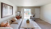 This single-floor residence on N Bartlett Ave in Milwaukee, WI offers a well-organized layout designed for comfortable everyday living. The living room serves as the heart of the unit, featuring neutral-toned carpet, a large sliding glass door that floods the space with natural light and provides views of the surrounding exterior. The open feel carries through to the adjacent dining area, which features wood-look flooring and overhead lighting, creating a clean and functional space for meals.

The kitchen is outfitted with white cabinetry, granite-style countertops, stainless steel appliances including a range, microwave, and refrigerator, and wood-look flooring that ties seamlessly into the dining area. The bedrooms feature plush carpeting, baseboard heating, and generously sized closets, including one bedroom with a walk-in closet. Each bedroom benefits from natural light through well-placed windows. The bathrooms are finished with wood-look tile flooring, granite-style vanity counters, and a walk-in shower with a curtain enclosure. Throughout the unit, neutral wall tones and consistent finishes create a cohesive and understated aesthetic.