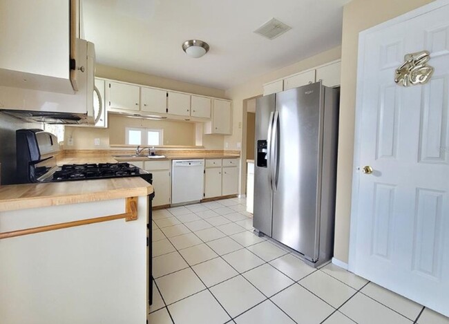 Building Photo - Charming 3-Bedroom Home with Pool, 2-Car Garage, and Tile Flooring Throughout!