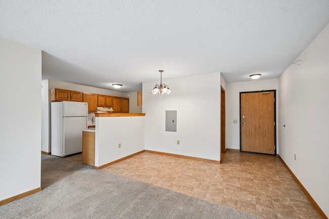 Step into the spacious living area at Mill Pond Apartments, where modern comfort meets functionality. Enjoy the open dining space and convenient kitchen layout. Schedule a tour today to see your future home! - Mill Pond Apartments