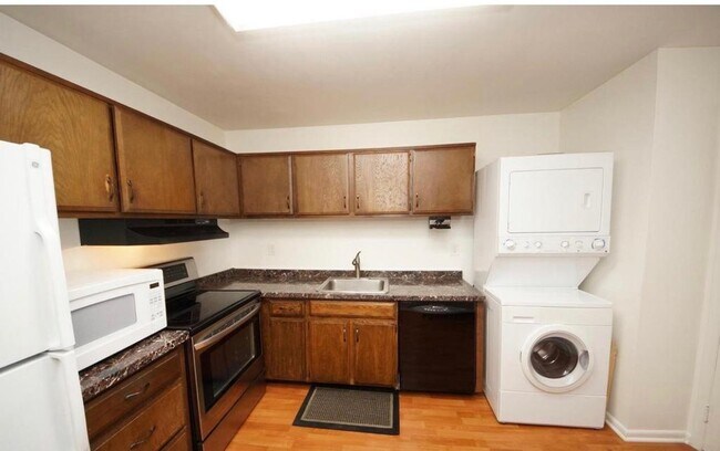 Kitchen with fridge, dishwasher, washing machine, dryer, and electric stove. - 10L Dennison Dr