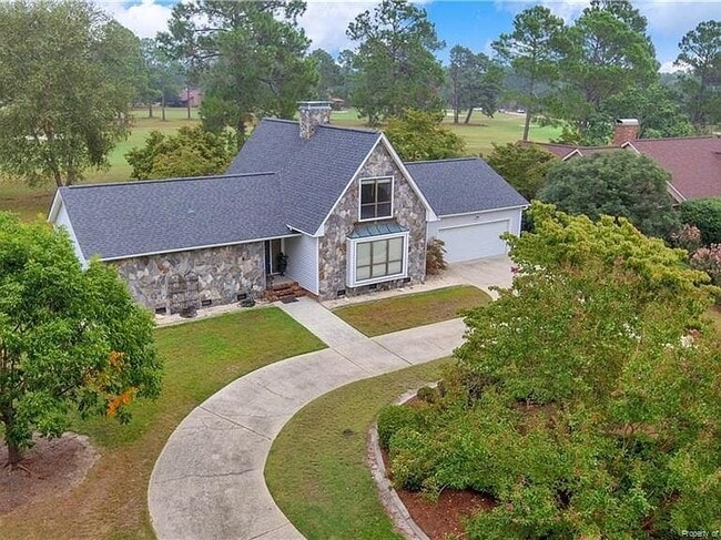 Welcoming entry with manicured lawn and wide driveway. - 6812 Uppingham Rd