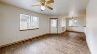 Located at 12330 SE Bush St in Portland, Oregon, this 2-bedroom, 2-bathroom single-floor residence offers a well-organized layout designed for comfortable everyday living. The open-concept living and dining area is finished with durable wood-look flooring and features large windows that fill the space with natural light, along with a ceiling fan and a pendant light fixture over the dining area. A front entry door with sidelights adds to the welcoming feel of the main living space. The kitchen is efficiently designed in a U-shape configuration, featuring warm oak cabinetry, a continuous laminate countertop with a breakfast bar pass-through, a stainless single-basin sink, and white appliances including a range, dishwasher, and refrigerator. Both bedrooms are carpeted and receive natural light through windows with views of the surrounding neighborhood. The primary bedroom is a generous size and includes its own closet. The bathrooms are finished with wood-look flooring, oak vanity cabinetry, and neutral countertops. Two closets provide dedicated storage throughout the home. A private outdoor balcony offers pleasant views of mature trees and the surrounding Portland landscape, completing this practical and comfortable residence.