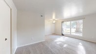 Located at 117 Olde Jamestowne Ct in Williamsburg, VA, this one-bedroom, one-bathroom home offers a well-organized, single-floor layout designed for comfortable everyday living. The combined living and dining area serves as the heart of the home, featuring soft wall-to-wall carpeting, a ceiling fan, and a large window that welcomes generous natural light and outdoor views of the surrounding neighborhood. The galley-style kitchen is efficiently laid out with bold navy-blue cabinetry, light-toned countertops, tile flooring, and white appliances including a refrigerator, electric range, and hood vent, providing all the essentials in a compact yet functional space. The bedroom offers a cozy, carpeted retreat with its own access to the hallway and benefits from natural light filtering through the windows. The bathroom is fitted with a full tiled tub-and-shower combination, finished in classic white. A standout feature of this home is its exceptional storage capacity, with four closets distributed throughout the floor plan, ensuring abundant space for organization. Clean white walls and neutral tones throughout create a bright, cohesive ambiance, making this Williamsburg residence a practical and inviting place to call home.