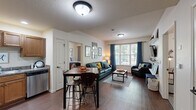 Located at 1855 Vaness St in South Bend, Indiana, this well-appointed 2-bedroom, 3-bathroom residence offers a thoughtfully designed single-floor layout. The open-concept living and dining area serves as the heart of the home, featuring rich hardwood-style flooring, a large window with teal curtains that invite natural light, and built-in wall shelving ideal for display and storage. A dining table with bar-height seating connects seamlessly to the living space, creating an efficient and social layout.

The kitchen is outfitted with warm wood cabinetry, granite-style countertops, recessed lighting, and full black appliance suite including a refrigerator, range, microwave, and dishwasher — all set on matching hardwood-style flooring.

Both bedrooms are carpeted and offer windows with curtains for privacy, providing a comfortable and quiet retreat. Each room is well-proportioned, with the primary bedroom offering a notably generous footprint. The unit includes three full bathrooms, ensuring ample convenience for residents and guests. A dedicated closet provides additional storage throughout the home. The overall ambiance is clean, bright, and functional — well-suited for everyday living near the University of Notre Dame.