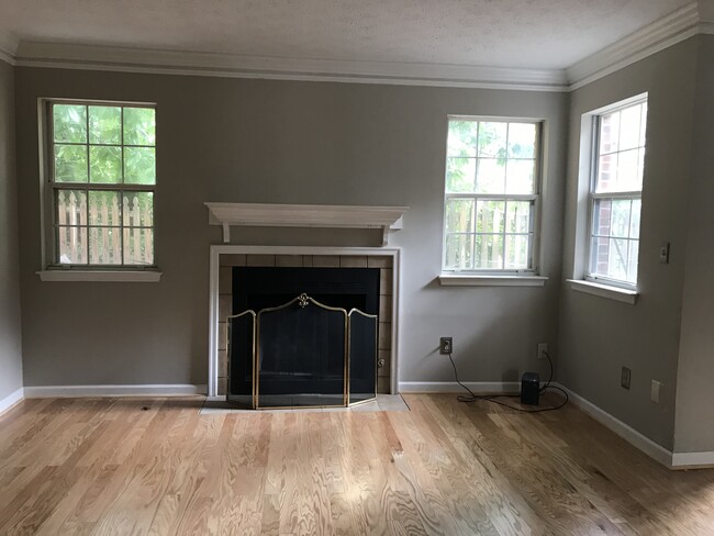 Living room with views of trees and cozy fireplace. - 107 Swanton Hill Ct