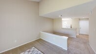 Located at 4550 47th St W in Bradenton, Florida, this one-bedroom, one-bathroom unit offers a straightforward single-floor layout designed for comfortable everyday living. The space is organized efficiently, featuring a hallway entry, a dedicated closet for storage, and a cohesive flow between rooms.

The living area showcases a split-level design element, with a raised partition wall separating spaces and adding architectural interest. Neutral beige walls and wall-to-wall carpeting create a warm, understated atmosphere throughout, while recessed lighting and a window allow natural light to filter in.

The bedroom is a well-proportioned room featuring plush carpeting, a ceiling fan with light fixture for year-round comfort, and a window with blinds that provides views of the surrounding outdoor greenery. The textured ceiling adds a classic Florida residential touch.

The bathroom is clean and functional, equipped with a vanity featuring a light-toned countertop, a large wall mirror, a toilet with an accessible grab bar, and a shower-tub combination enclosed by a decorative curtain. Warm neutral tones carry throughout, maintaining a consistent aesthetic across the unit.

Overall, this unit offers a practical and cozy living environment suitable for individuals or couples seeking a manageable, low-maintenance home in Bradenton, FL.