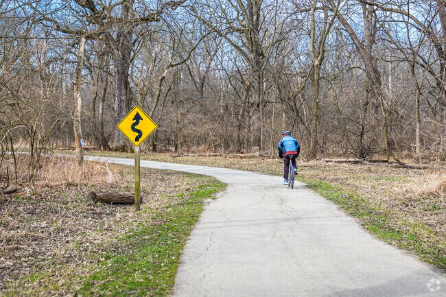 A cyclist enjoys a ride in Salt Creek Woods Nature Preserve.
