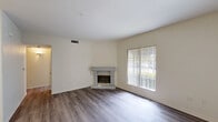 Located on Sunflower Road in Murrieta, CA, this single-story, 3-bedroom, 2-bathroom home offers a well-organized and functional layout. The living room is bright and spacious, featuring wood-style flooring, a classic fireplace with a decorative mantle, and large windows with vertical blinds that invite an abundance of natural light. A sliding glass door opens to an outdoor view of lush greenery, seamlessly connecting the interior to the outside. The galley-style kitchen is efficiently designed with warm honey-toned wood cabinetry, white tile countertops, a full suite of white appliances, and a skylight-style overhead fixture that keeps the space well-lit. An adjoining dining area with a ceiling fan provides a comfortable space for meals. The three bedrooms are well-proportioned, with the generously sized primary bedroom offering ample space and natural light. Both bathrooms are clean and functional, each featuring a tub-shower combination with white tile surround, and one includes a vanity with a mirrored medicine cabinet and wood-style flooring. A dedicated laundry room houses a full-size side-by-side washer and dryer beneath built-in white upper cabinetry, adding everyday convenience to this practical home.
