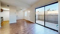 This contemporary townhouse in Fullerton, CA offers a compact yet efficient living space spread across two floors. The 750 square foot interior is thoughtfully designed, featuring 2 bedrooms and 3 bathrooms. The ground floor, spanning 340 square feet, includes an open-concept living area with hardwood flooring and a sliding glass door leading to an outdoor patio, enhancing the sense of space and light. The kitchen boasts modern appliances and granite countertops, with wooden cabinetry adding warmth to the space. Upstairs, the 410 square foot area houses the bedrooms, including a spacious 180 square foot primary bedroom. Bathrooms are well-appointed with granite vanities and wood-look flooring. Large windows and neutral wall colors throughout create a bright, airy atmosphere. A carpeted staircase connects the two levels, while built-in closets in the bedrooms provide ample storage. This residence balances functionality with contemporary style, offering a comfortable living environment in a desirable location.