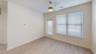 This thoughtfully designed single-floor residence offers three bedrooms, three bathrooms, and two closets within a comfortable and efficiently laid-out floor plan. The open-concept kitchen and living area serves as the heart of the home, showcasing a striking two-tone cabinet design with navy lower cabinets and crisp white upper cabinets, complemented by light quartz countertops, a subway tile backsplash, and stainless steel appliances including a range, microwave, and refrigerator. A center island with pendant lighting adds both function and style, while light wood-look flooring flows throughout the main living areas. Each bedroom features plush carpeting and ceiling fans with lighting, and the rooms are brightened by windows with blinds that allow for natural light control. The primary bedroom includes a well-organized walk-in closet with built-in shelving and hanging rods. The bathrooms are finished with navy vanity cabinetry, white countertops, large mirrors, and tiled shower-tub combinations with brushed nickel fixtures. Clean white walls and neutral tones throughout create a bright, modern ambiance that is both inviting and move-in ready.
